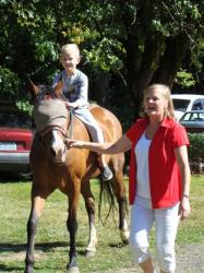 Jan leads a reunion attendee on her horse